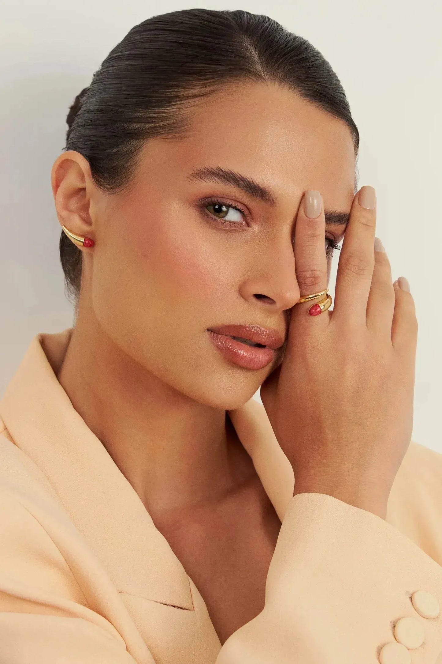 O Brinco Momento com Feldspato Vermelho em Banho de Ouro 18K é uma joia que combina a energia vibrante do Feldspato com a nobreza do Ouro, ideal para um toque de cor e luxo discreto.