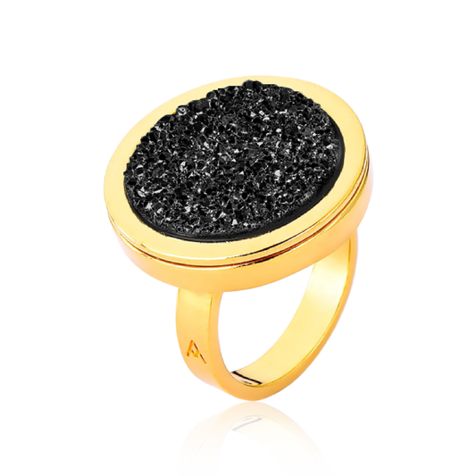 O Anel Único - Drusa Negra integra a Coleção Singular, celebrando a sofisticação e o mistério da mulher contemporânea. A Drusa Negra é uma pedra de forte conexão com a proteção, absorção de energias negativas e fortalecimento espiritual. Banhado a Ouro 18K, este anel cria um contraste luxuoso entre o brilho dourado e a textura bruta e cintilante da drusa, resultando em uma peça imponente e repleta de personalidade.